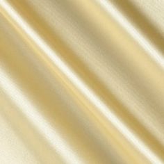 an image of a plain white fabric textured with light gold color and soft folds