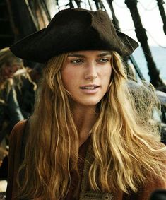 a woman with long hair wearing a pirate hat