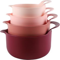 four bowls stacked on top of each other in pink, red and white dishes with handles