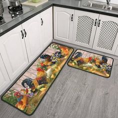 two kitchen mats with roosters and flowers on them in the middle of a kitchen