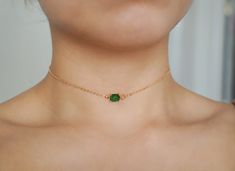 Simple little choker necklace featuring a cute little emerald gemstone. This may be made into a choker necklace or a regular length necklace. Stone measures: 1cm x 0.6cm Ensure to measure neck with measuring tape in inches. (You may want to leave a little extra room so your necklace is not too tight) Please choose your length of necklace at checkout. Green Clavicle Chain Choker As A Gift, Green Clavicle Chain Choker For Gift, Green Clavicle Chain Choker Gift, Green Minimalist Choker Jewelry, Green Stone Choker Necklace, Emrald Beeds Choker, Dainty Green Choker Necklace, Dainty Green Adjustable Choker, Dainty Emerald Gemstone Necklace For Gift