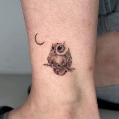 an owl with a crescent moon tattoo on the ankle