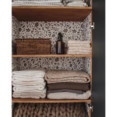 an organized closet with linens and blankets