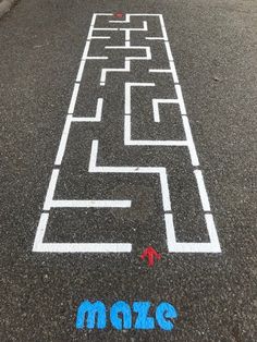 an image of a maze on the street with words make it written in blue and white