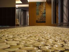 the floor is covered with water droplets in front of a large painting on the wall