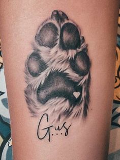 a dog paw with the word gus written on it