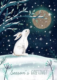 a white rabbit sitting on top of a snow covered hill next to a tree and moon