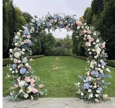 an outdoor wedding arch decorated with flowers and greenery