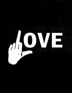 the word love is written in white on a black background with a hand pointing at it