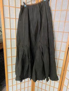 Very cool antique silk skirt with button details. In fair condition, several holes and rips, see all photos! Unfinished waist closureWaist: 27-29”Waist to hem: 30” Black Pleated Silk Skirt, Black Silk Maxi Skirt For Spring, Black Silk Flared Skirt, Black Silk Pleated Skirt Bottoms, Fitted Black Silk Maxi Skirt, Fitted Silk Black Maxi Skirt, Black Silk Bottoms With Pleated Skirt, Gothic Evening Skirt For Spring, Vintage Costume Gathered Skirt