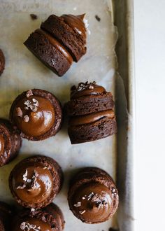 chocolate cupcakes with frosting on a baking sheet