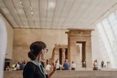 a woman is standing in front of the lincoln memorial