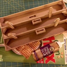 an open box with waffles and peanut butter on it next to some scissors