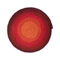 an orange and red circular rug on a white background with room for text or image