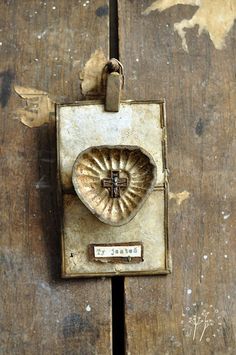 an old door handle with a heart on it