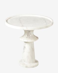 a white marble cake stand on a white background