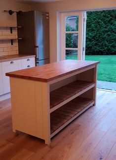 a kitchen with an island and sliding glass doors leading to the back yard, outside