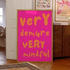 there is a pink sign that says very demure very mindful on the wall