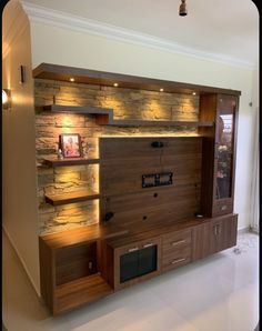 an entertainment center with built in shelves and lights