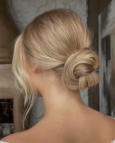 a woman with blonde hair in a low bun