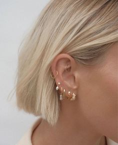 Our Biarritz Mini Hoops are the season's most coveted earring, featuring staggered baguette quartz stones creating a subtle element of sparkle that is sure to elevate any look. Crafted from high quality 925 sterling silver with 18k gold plating (gold vermeil) Set with AAA quality clear CZ stones Outer diameter 14mm Nickel free & hypoallergenic Will arrive beautifully packaged in our branded pouch Mixing Gold And Silver Earrings, Gold And Silver Earring Stack, Silver Earring Stack, Ušný Piercing, Ear Stack, Saint Valentine, Single Earring, Gold Drop Earrings, Jewelry Inspo