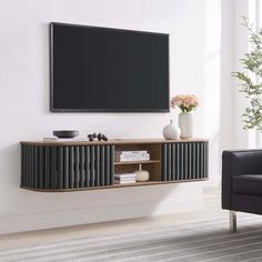 a living room with a large television mounted on the wall