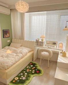 a bed room with a neatly made bed next to a desk and chair in front of a window