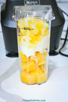 a blender filled with oranges and yogurt