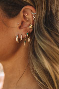 a close up of a person with ear piercings