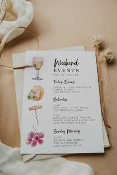 a menu for a wedding with wine glasses and flowers on the table next to it