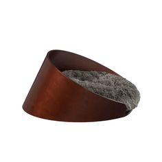 a metal bowl with a fur inside it