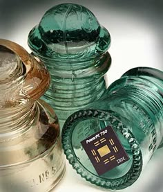 three green glass jars sitting next to each other