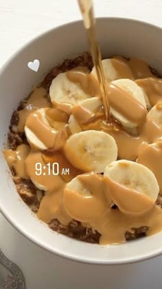 a bowl filled with oatmeal topped with bananas and peanut butter