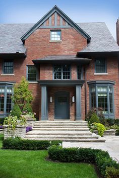 a large brick house with steps leading to the front door