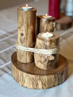 three wooden candles sitting on top of a table