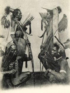 an old black and white photo of three native american women with arrows in their hands