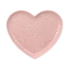 a pink heart shaped dish with roses on it