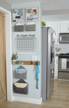 a refrigerator with magnets and pictures on the wall next to an open door in a kitchen