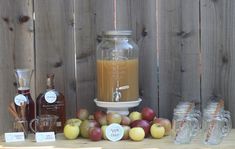 apples, honey and other ingredients are on a table next to a glass jar with a liquid in it