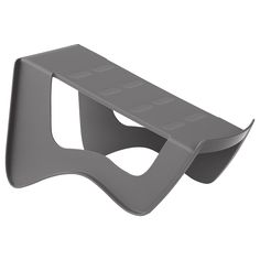 a gray plastic shelf with two holes on it