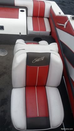 red and white seats on a boat in the water