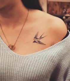 a woman with a bird tattoo on her chest