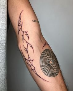 a man's arm with a tattoo on it that has a maze in the middle