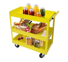 a yellow cart filled with lots of food and condiments on top of it