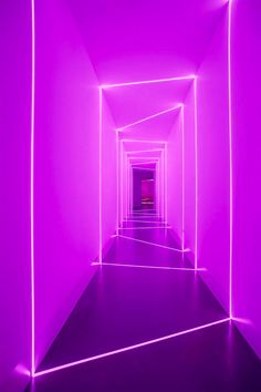 an empty hallway with bright purple lighting