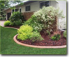 the front yard is neatly trimmed and ready to be used as a flower bed or planter