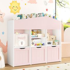 a child's playroom with pink furniture and wall decals on the walls