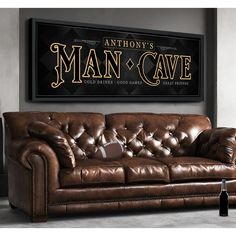 a couch and table in front of a man cave sign