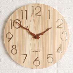 a wooden clock with numbers on the face