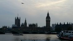 the big ben clock tower towering over the city of london on a foggy day